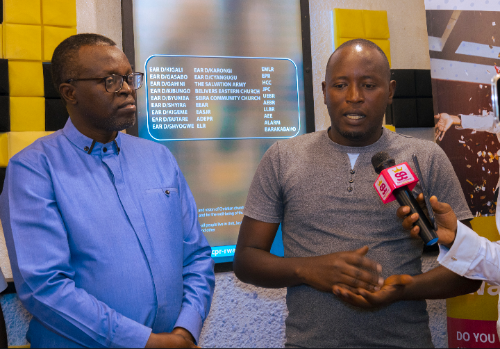 Didace Niyifasha standing with Rev. Samuel Mutabazi, High Secretary of CPR, during his award presentation ceremony.