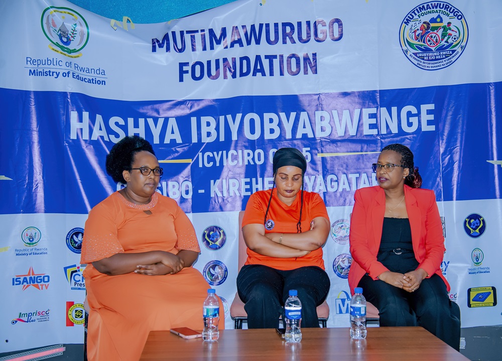 Uwineza Marie Claire sitting in the center with Mujawayezu Francoise, in charge of Wellbeing at the Foundation, on the left, and Agatezi Marie Leatitia, CEO of ISANGO STAR and one of the campaign's biggest supporters, on the right wearing red and black. They are at the official press conference launching the campaign against drug abuse.